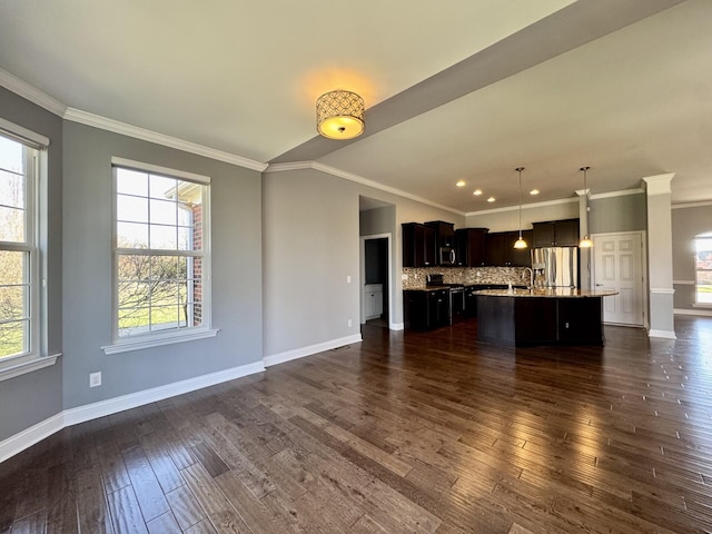unfurnished living room featuring baseboards, dark wood finished floors, and ornamental molding