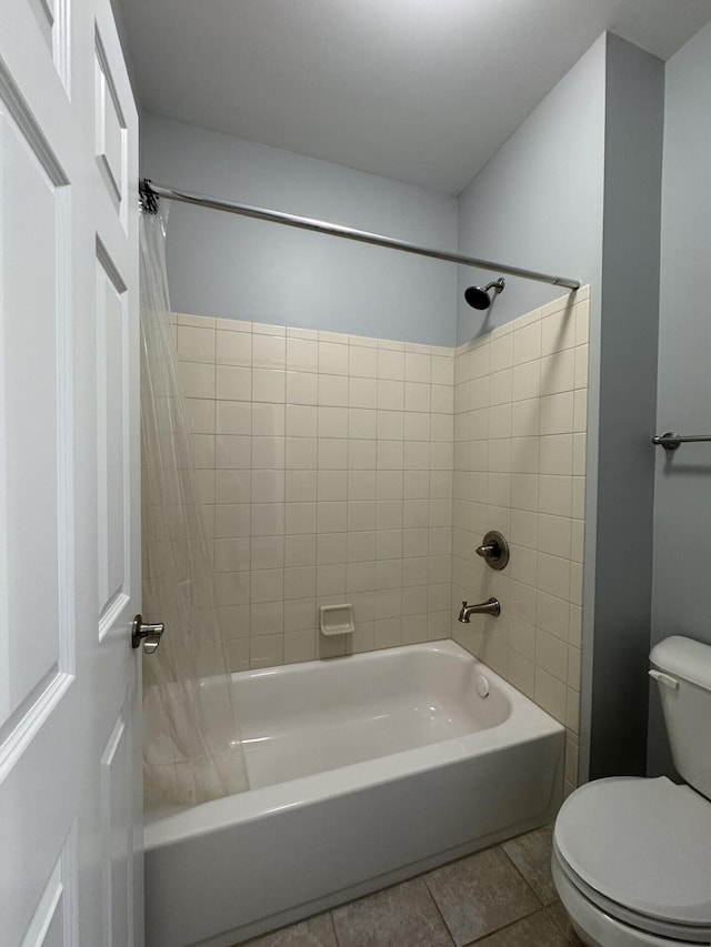 bathroom featuring toilet, shower / bathtub combination with curtain, and tile patterned flooring