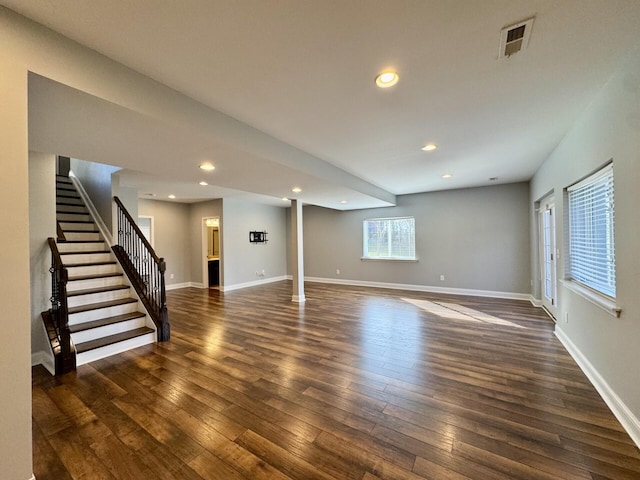 below grade area featuring stairs, dark wood-type flooring, recessed lighting, and baseboards