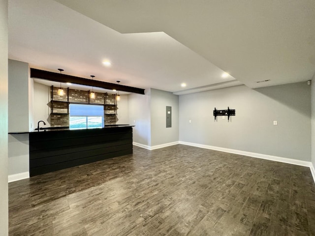 unfurnished living room featuring dark wood-style floors, baseboards, recessed lighting, and electric panel