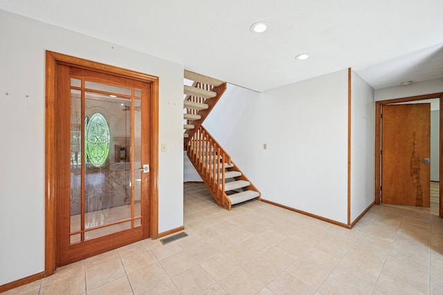 foyer featuring stairs, recessed lighting, and baseboards