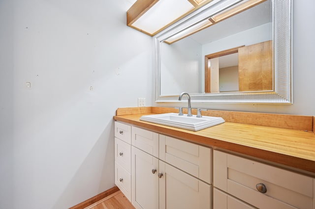 bathroom with vanity and baseboards