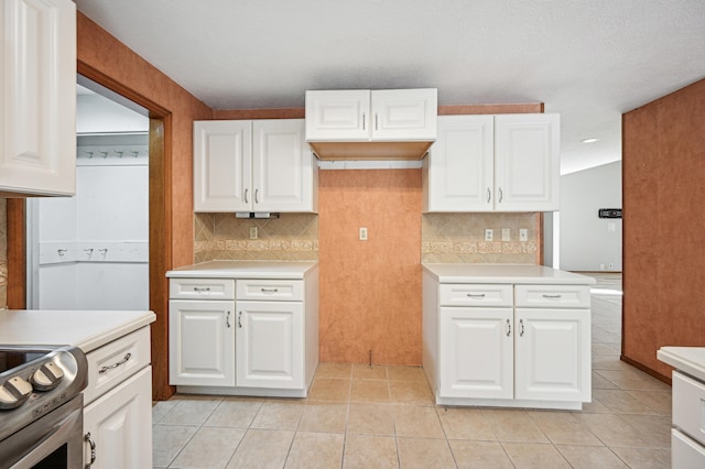 kitchen featuring light countertops, decorative backsplash, and white cabinetry