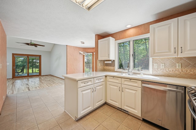 kitchen with appliances with stainless steel finishes, light tile patterned floors, backsplash, light countertops, and recessed lighting