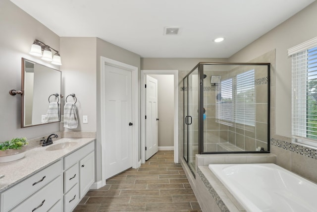 574 Ravensridge Ct, Alexandria, KY 41001 - full bath with a bath, vanity, a stall shower, plenty of natural light, and recessed lighting