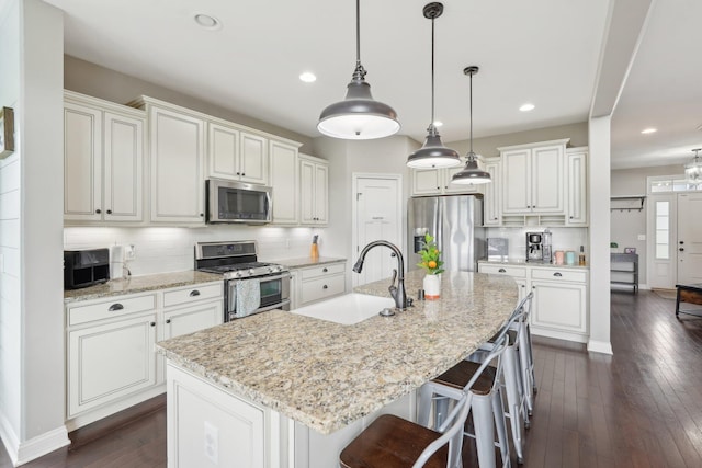 574 Ravensridge Ct, Alexandria, KY 41001 - kitchen with appliances with stainless steel finishes, a sink, tasteful backsplash, dark wood finished floors, and white cabinetry