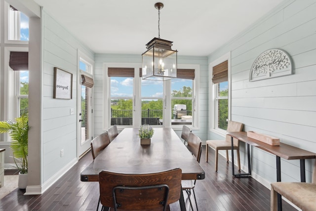 574 Ravensridge Ct, Alexandria, KY 41001 - dining area with dark wood-style floors, wood walls, crown molding, a chandelier, and baseboards