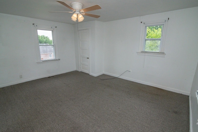 3213 Decoursey Ave, Covington, KY 41015 - empty room with plenty of natural light, ceiling fan, and dark colored carpet