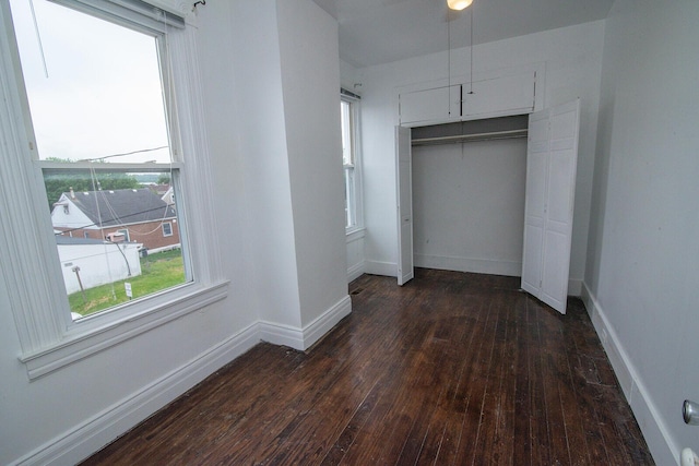 3213 Decoursey Ave, Covington, KY 41015 - unfurnished bedroom featuring dark wood-style floors, a closet, and baseboards