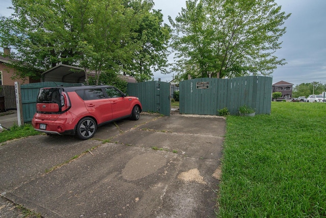 3213 Decoursey Ave, Covington, KY 41015 - view of parking with fence, a gate, and a carport