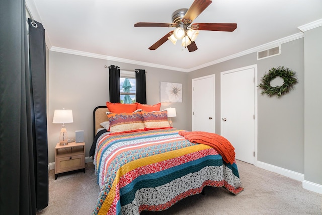 carpeted bedroom with crown molding, baseboards, and ceiling fan
