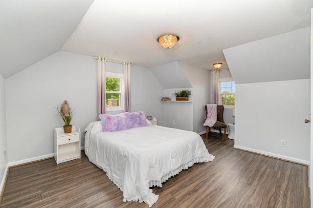 bedroom with vaulted ceiling, multiple windows, wood finished floors, and baseboards