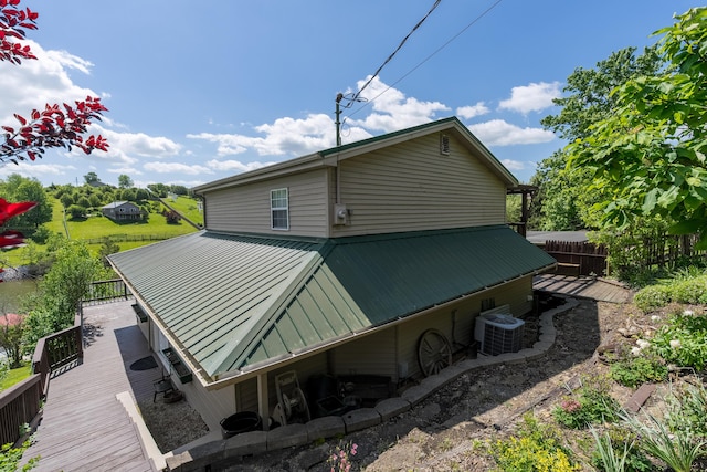 335 Fernwood Dr, Williamstown, KY 41097 - back of property featuring metal roof, cooling unit, fence, a standing seam roof, and a deck