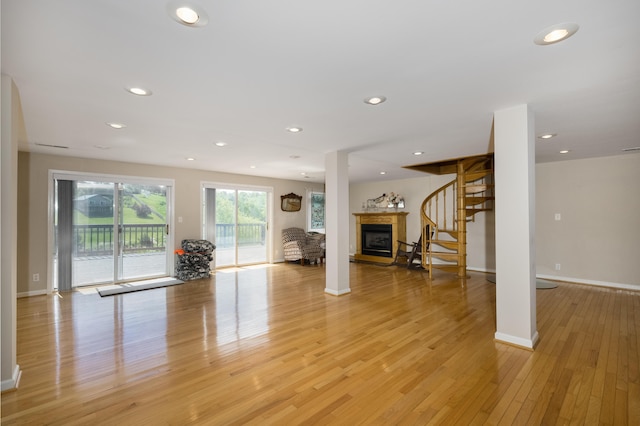 335 Fernwood Dr, Williamstown, KY 41097 - living room featuring stairs, light wood-style flooring, a fireplace with raised hearth, baseboards, and recessed lighting