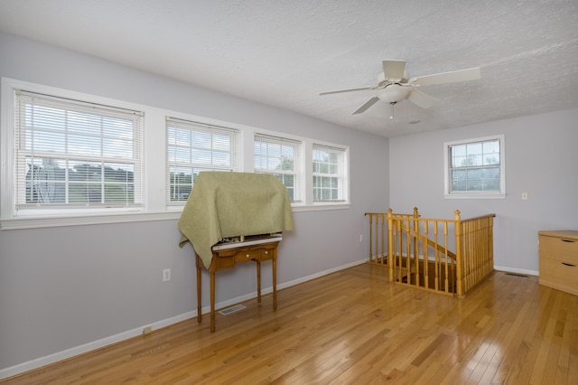 335 Fernwood Dr, Williamstown, KY 41097 - spare room featuring light wood finished floors, baseboards, ceiling fan, and a textured ceiling