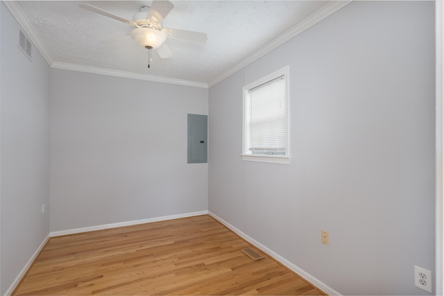 335 Fernwood Dr, Williamstown, KY 41097 - spare room featuring electric panel, light wood-style flooring, baseboards, ornamental molding, and a ceiling fan