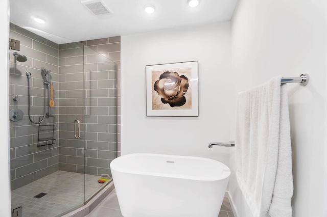 120 Main St Unit 306, Newport, KY 41071 - bathroom with a stall shower, tile patterned flooring, a freestanding tub, and recessed lighting