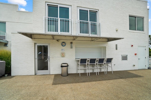120 Main St Unit 306, Newport, KY 41071 - back of property featuring brick siding, a patio area, and a balcony