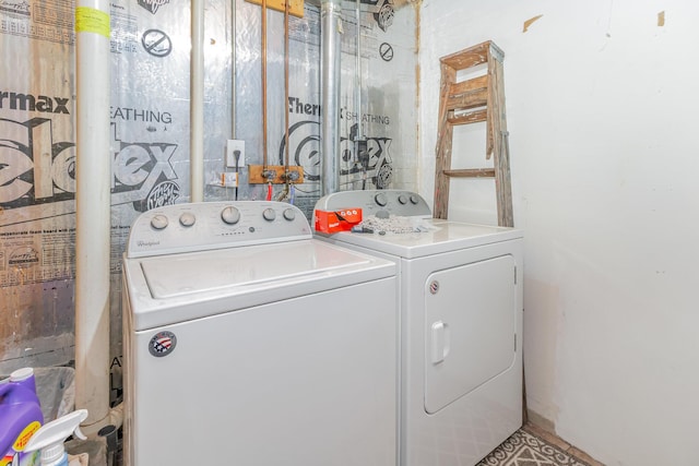 clothes washing area with washer and clothes dryer