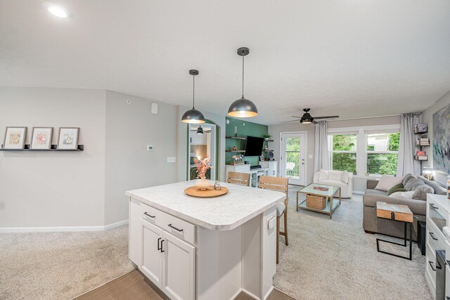 2263 Piazza Rdg, Covington, KY 41017 - kitchen featuring ceiling fan, open floor plan, white cabinets, a center island, and hanging light fixtures