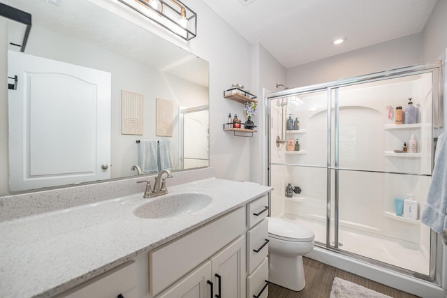 2263 Piazza Rdg, Covington, KY 41017 - full bath with toilet, a shower stall, vanity, wood finished floors, and recessed lighting