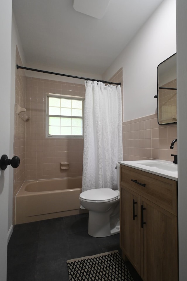 529 Stevenson Rd, Erlanger, KY 41018 - bathroom with toilet, vanity, shower / bath combo with shower curtain, tile walls, and tile patterned flooring