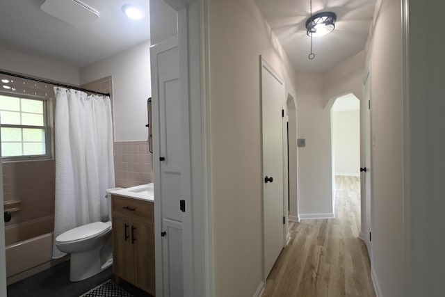 529 Stevenson Rd, Erlanger, KY 41018 - bathroom featuring vanity, wood finished floors, toilet, shower / tub combo with curtain, and tile walls