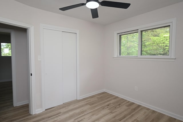 529 Stevenson Rd, Erlanger, KY 41018 - unfurnished bedroom with light wood-style flooring, baseboards, a closet, and a ceiling fan