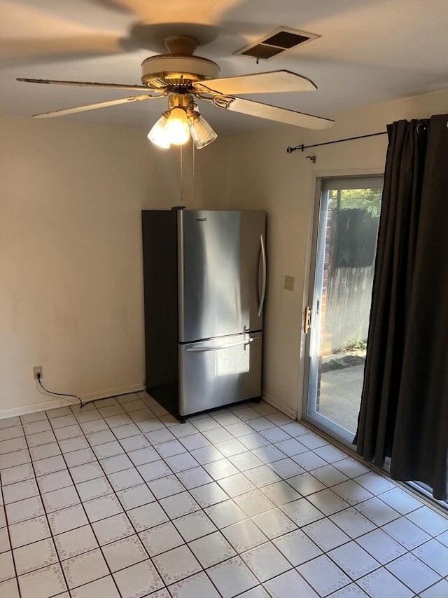 spare room featuring light tile patterned floors and a ceiling fan