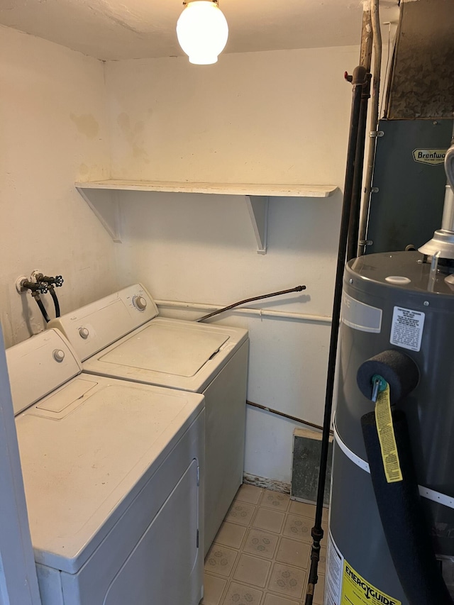 laundry area featuring washing machine and dryer, water heater, and light floors