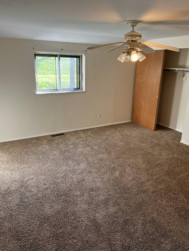 unfurnished bedroom featuring carpet flooring, a closet, ceiling fan, and baseboards