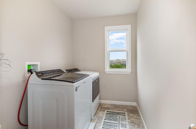 laundry area featuring washing machine and clothes dryer and baseboards