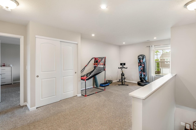 exercise room with carpet flooring, recessed lighting, and baseboards
