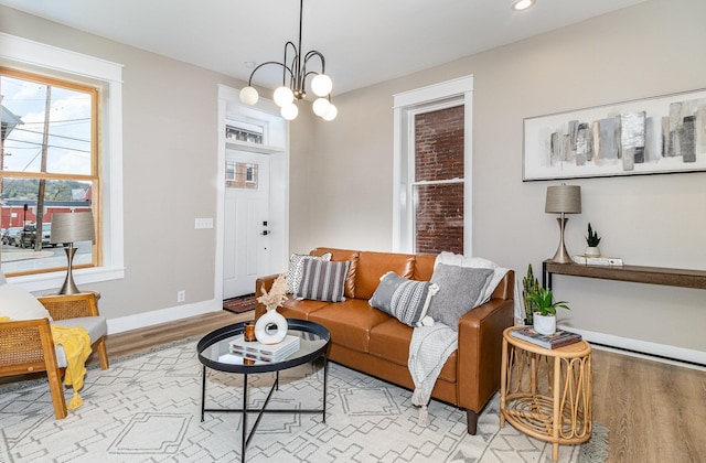 1102 Lee St, Covington, KY 41011 - living area featuring light wood-type flooring, baseboards, a chandelier, and recessed lighting