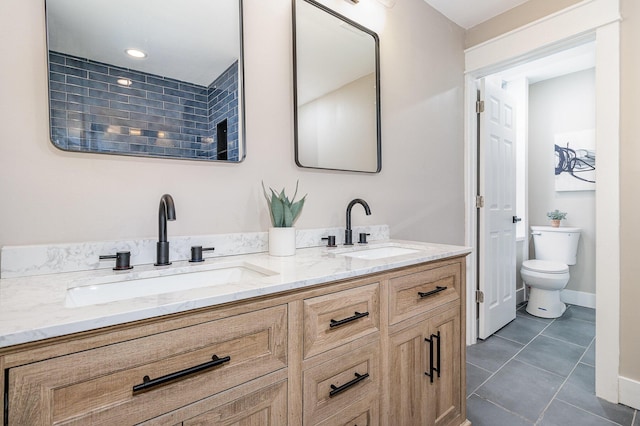 1102 Lee St, Covington, KY 41011 - bathroom featuring toilet, double vanity, and tile patterned flooring