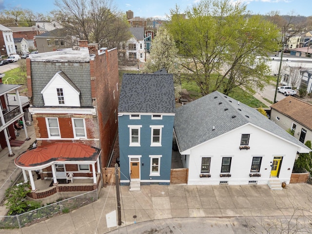 1102 Lee St, Covington, KY 41011 - view of front of house with fence, a residential view, a shingled roof, brick siding, and a patio