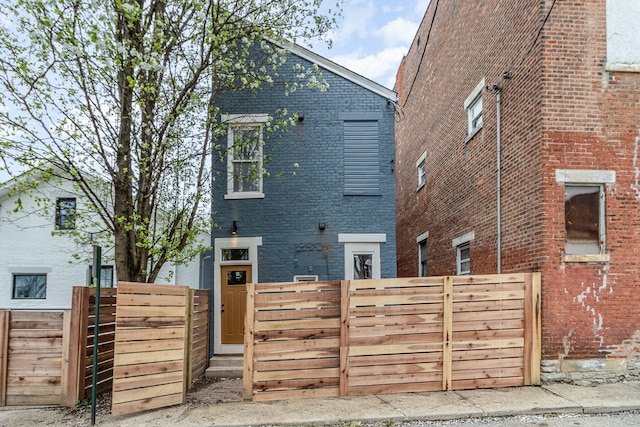 1102 Lee St, Covington, KY 41011 - back of house featuring brick siding and fence
