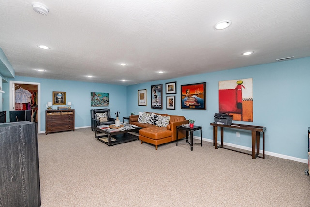 carpeted living area featuring recessed lighting and baseboards