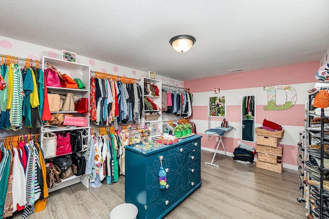 spacious closet with wood finished floors