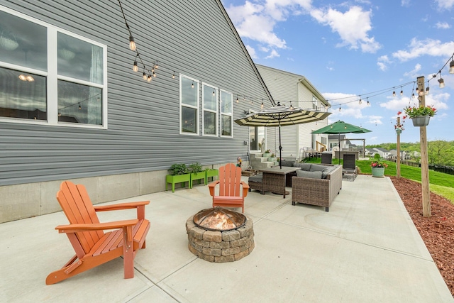 view of patio / terrace with an outdoor living space with a fire pit