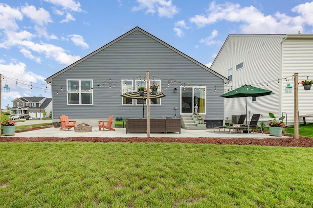 back of property with entry steps, a fire pit, a patio, and a yard