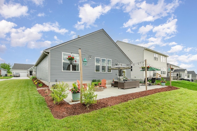 rear view of property with an outdoor living space, a patio area, and a lawn