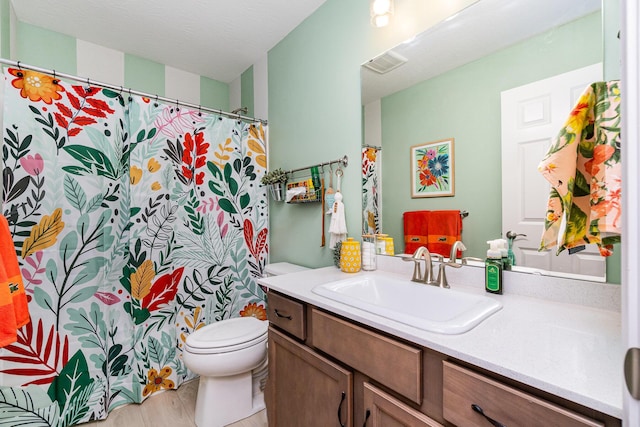 full bathroom with toilet and vanity