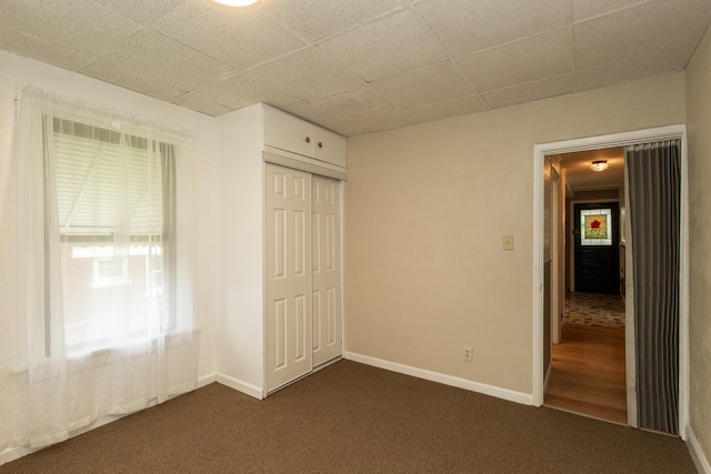 1101 Mckinney Ave, Dayton, KY 41074 - unfurnished bedroom with dark colored carpet, a closet, and baseboards