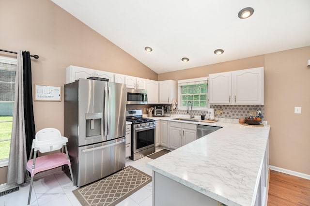 37 Pinhook Pl, Crittenden, KY 41030 - kitchen featuring stainless steel appliances, a sink, a peninsula, white cabinetry, and vaulted ceiling