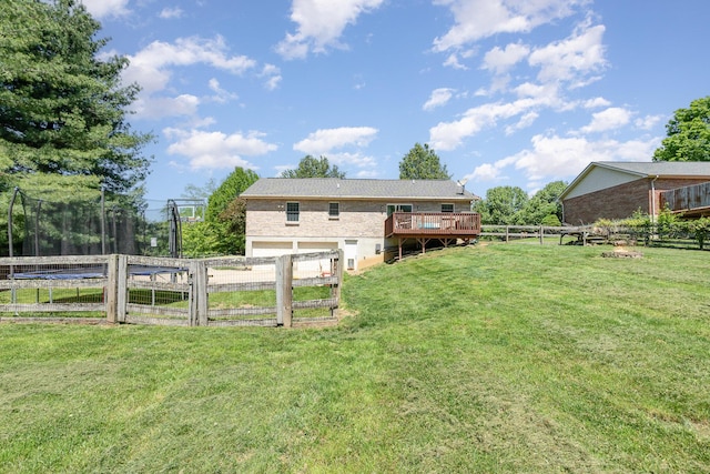37 Pinhook Pl, Crittenden, KY 41030 - rear view of house featuring a trampoline, an attached garage, a wooden deck, driveway, and brick siding