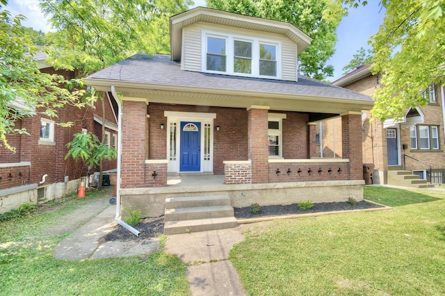 24 Holmesdale Ct, Covington, KY 41014 - view of front of property with brick siding, a front lawn, a porch, and roof with shingles