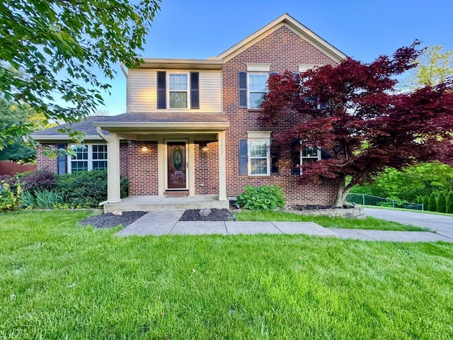 1317 Brook Ct, Erlanger, KY 41018 - traditional home featuring a front yard, brick siding, and a porch