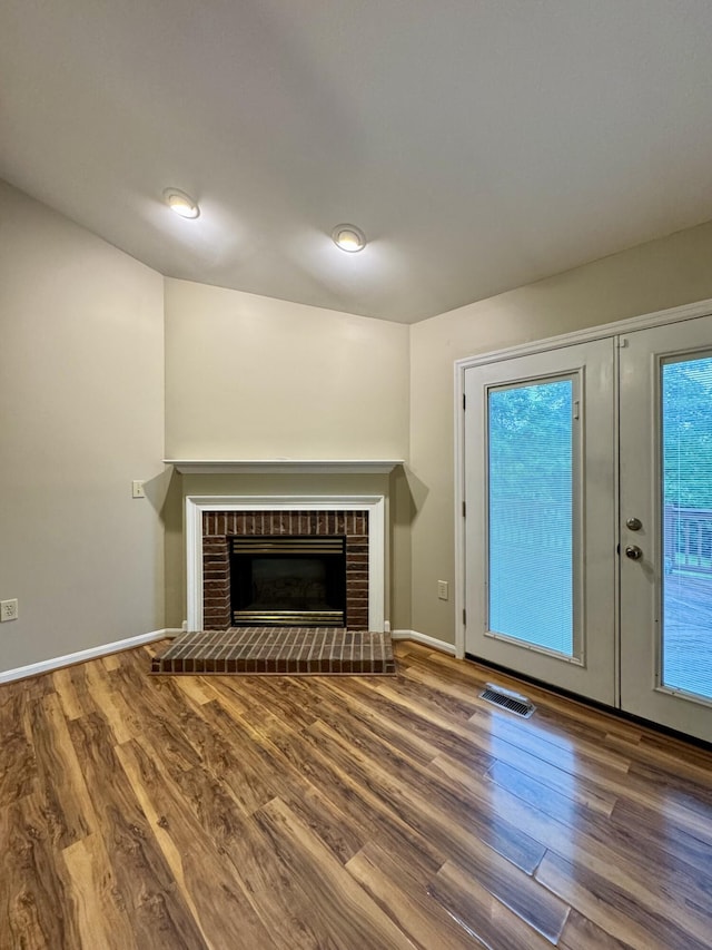 1317 Brook Ct, Erlanger, KY 41018 - unfurnished living room featuring wood finished floors, baseboards, a brick fireplace, and french doors