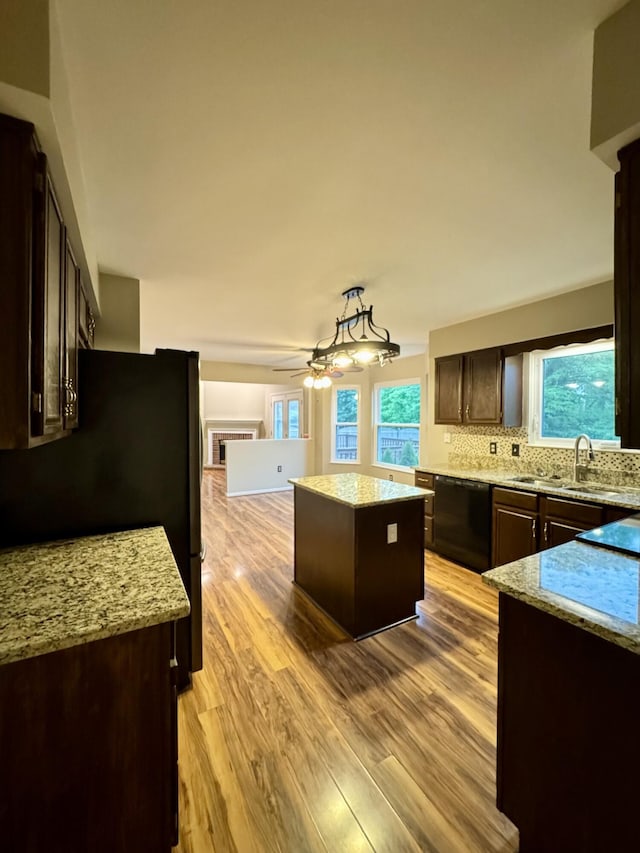 1317 Brook Ct, Erlanger, KY 41018 - kitchen with black appliances, a sink, dark brown cabinetry, a kitchen island, and light wood-type flooring